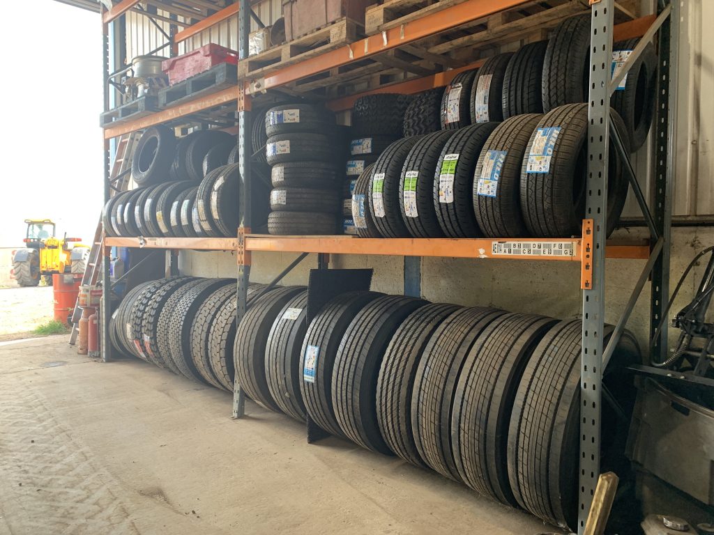 A full range of budget to premium HGV and commercial vehicle tyres stored in racking.